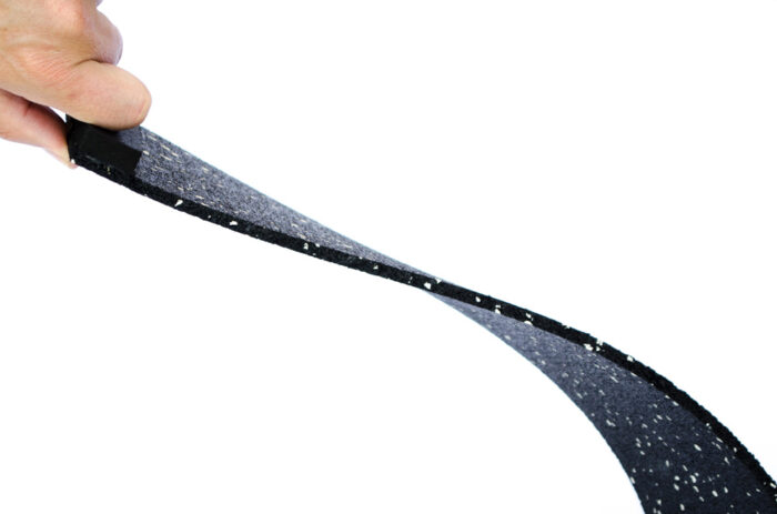 A person holding onto the end of a black strap
